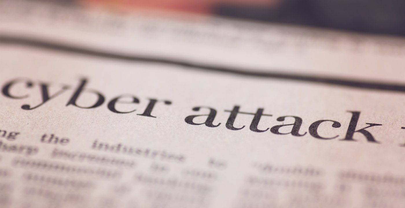 newspaper with a headline about cyber attacks