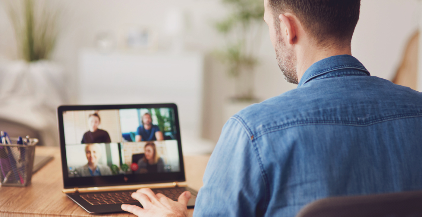 Man looking at a laptop while video conferencing